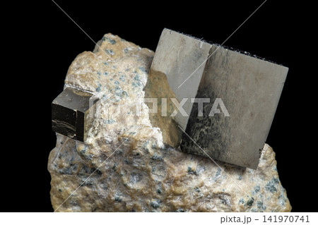 Macro Pyrite mineral stone on black background 141970741