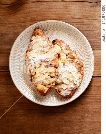 Almond Croissants with Powdered Sugar on Plate 141970800