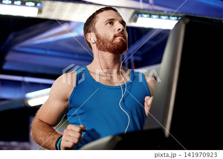 Earphones, runner and man running on treadmill in gym for health, wellness and body weight loss. Exercise, fitness and male athlete with cardio workout on machine for race training in sports center. Earphones, runner and man running on treadmill in gym for health, wellness and body weight loss. Exercise, fitness and male athlete with cardio workout on machine for race training in sports center. 141970923