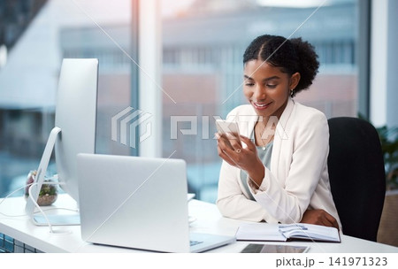 Business woman, office and phone text with a content creation administrator with social media break. Desk, creative agency and African professional with internet, app and smile from online message Business woman, office and phone text with a content creation administrator with social media break. Desk, creative agency and African professional with internet, app and smile from online message 141971323