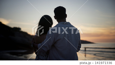 Couple, sunset and hug at beach for travel, sightseeing and romantic date on holiday getaway. Back, people and embrace at seashore with ocean view, commitment and tropical vacation for adventure trip Couple, sunset and hug at beach for travel, sightseeing and romantic date on holiday getaway. Back, people and embrace at seashore with ocean view, commitment and tropical vacation for adventure trip 141971336