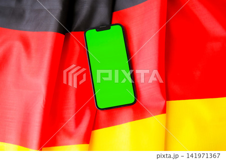 Green smartphone phone chromakey screen National symbol of Germany. Mock up advertisement template German wave Germany fabric flag background. Copy space for your text. Independence Green smartphone phone chromakey screen National symbol of Germany. Mock up advertisement template German wave Germany fabric flag background. Copy space for your text. Independence 141971367