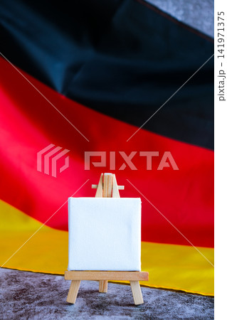 Empty white paper frame National symbol of Germany. Mock up advertisement template German wave Germany fabric flag background. Copy space for your text. Independence Empty white paper frame National symbol of Germany. Mock up advertisement template German wave Germany fabric flag background. Copy space for your text. Independence 141971375