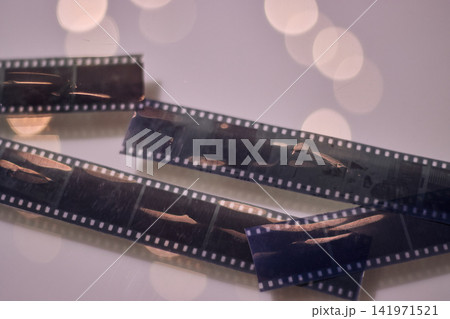 View of photographic rolls showing some of their scenes, with dim lighting, and in good condition. Displayed to the public. Analog, vintage, retro photography. 141971521