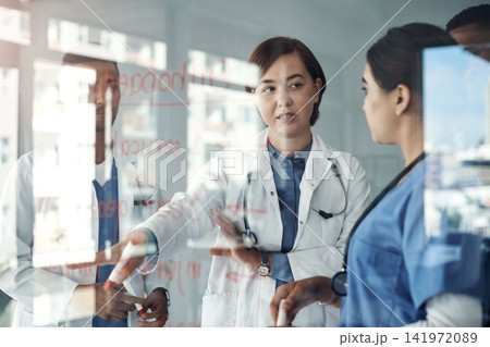 Doctor, people and team work on glass board for medical solution, brainstorming or problem solving in internship. Healthcare student or nurse talking, training and giving advice for orthopedic steps 141972089