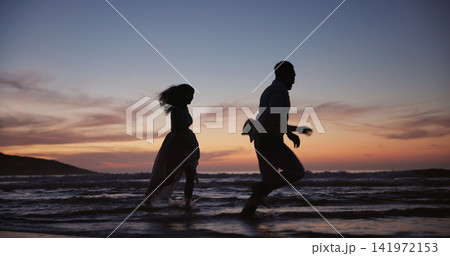Silhouette, couple and running at beach for travel, journey and romantic date on holiday. Space, sunset and people at seashore with happiness, commitment and tropical vacation for adventure getaway Silhouette, couple and running at beach for travel, journey and romantic date on holiday. Space, sunset and people at seashore with happiness, commitment and tropical vacation for adventure getaway 141972153