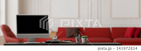 3D Illustration of Modern Office Desk with Blank Monitor Screen and Wall Art Frames in Stylish Interior 141972814