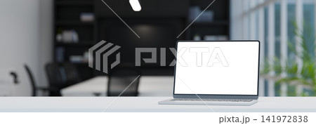 3D Render of Laptop with Blank White Screen Mockup on White Desk in Modern Office Workspace 141972838