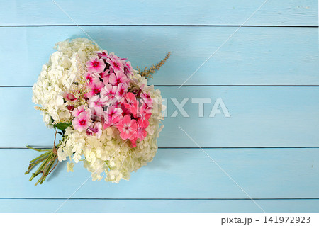 Bouquet of various varieties of phlox and garden hydrangea on a bright sunny background, an advertising banner for summer and autumn products, an abstract floral arrangement, a flat lay still life, Bouquet of various varieties of phlox and garden hydrangea on a bright sunny background, an advertising banner for summer and autumn products, an abstract floral arrangement, a flat lay still life, 141972923