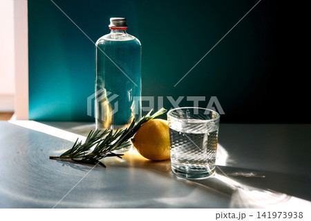 Healthy hydration with water bottle, glass, lemon, and rosemary Healthy hydration with water bottle, glass, lemon, and rosemary 141973938