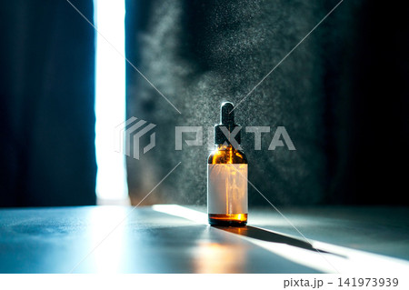 Amber dropper bottle with product mist for skincare concept Amber dropper bottle with product mist for skincare concept 141973939