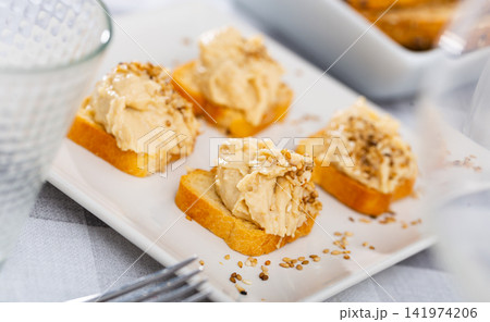 Four hummus sandwiches are laid out on plate - traditional snack of Middle East. 141974206