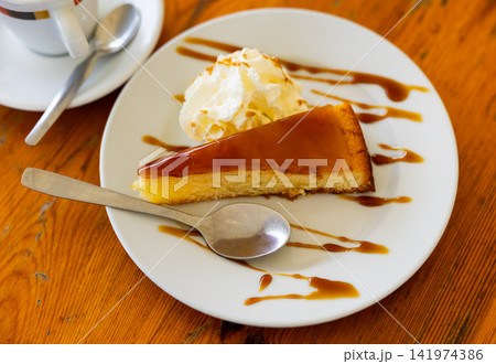 Restaurant dessert on plate - triangular piece of catalan cream pie with caramel syrup and ice cream 141974386