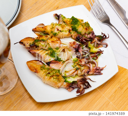 Traditional asian dish is barbecue squid,drizzled with spinach sauce. Traditional asian dish is barbecue squid,drizzled with spinach sauce. 141974389