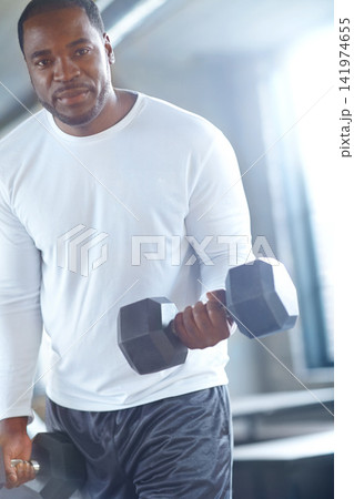 Portrait, athlete or black man with dumbbell in workout, fitness training or exercise for grip power. Lift, bodybuilding or strong bodybuilder with weights for pump, sports challenge or energy in gym Portrait, athlete or black man with dumbbell in workout, fitness training or exercise for grip power. Lift, bodybuilding or strong bodybuilder with weights for pump, sports challenge or energy in gym 141974655