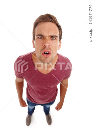 Stress, top view and portrait of angry man in studio frustrated, annoyed or defensive on white background. Face, frown and male model with aggressive reaction conflict, trauma or confrontation Stress, top view and portrait of angry man in studio frustrated, annoyed or defensive on white background. Face, frown and male model with aggressive reaction conflict, trauma or confrontation 141974774