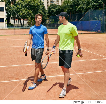 Sports, tennis and men with game, training and teamwork for competition, rackets and conversation. People, players and friends with sunshine, fitness and partnership with hobby, workout and challenge Sports, tennis and men with game, training and teamwork for competition, rackets and conversation. People, players and friends with sunshine, fitness and partnership with hobby, workout and challenge 141974882
