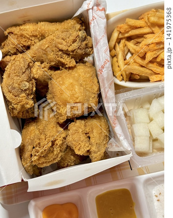 Crispy Korean fried chicken, perfectly glazed with a sweet and spicy sauce. Ideal for food photography and menus, showcasing the irresistible crunch and flavor of this beloved dish. Crispy Korean fried chicken, perfectly glazed with a sweet and spicy sauce. Ideal for food photography and menus, showcasing the irresistible crunch and flavor of this beloved dish. 141975368