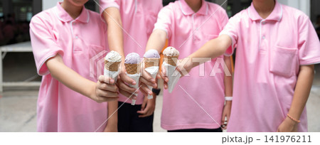 Joyful kids gathered outdoors with ice cream, celebrating summer and childhood companionship through a playful moment filled with smiles, sweetness, and togetherness. Joyful kids gathered outdoors with ice cream, celebrating summer and childhood companionship through a playful moment filled with smiles, sweetness, and togetherness. 141976211