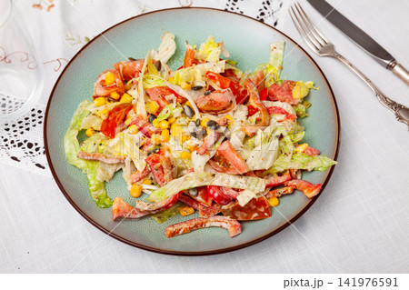 On plate, portion is laid out with pim salad of corn, cabbage, mayonnaise. On plate, portion is laid out with pim salad of corn, cabbage, mayonnaise. 141976591