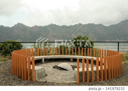 Visitors relax at a modern bench while enjoying mountain views 141979232