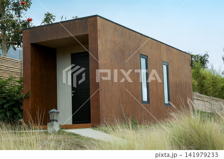Exploring a contemporary cabin surrounded by lush greenery Exploring a contemporary cabin surrounded by lush greenery 141979233