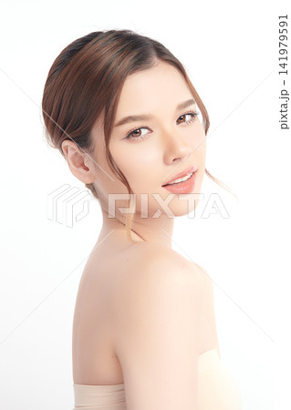 A beautiful young Asian woman with clean, fresh skin against a white background. Skincare, facial treatment, cosmetology, beauty, and spa. An elegant portrait of an Asian woman. A beautiful young Asian woman with clean, fresh skin against a white background. Skincare, facial treatment, cosmetology, beauty, and spa. An elegant portrait of an Asian woman. 141979591