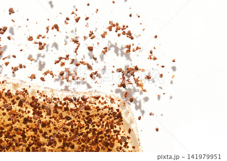 Instant Coffee Granules Airborne And Spilling From Toast Corner On White Background With Scattered Instant Coffee Granules Airborne And Spilling From Toast Corner On White Background With Scattered 141979951