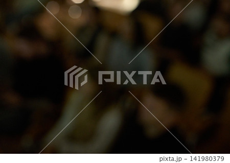 Audience Sitting Dark And Heavily Blurred During Indoor Event In Dim Auditorium With Indistinct 141980379