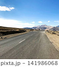 Empty Mountain Road Under Clear Blue Sky 141986068