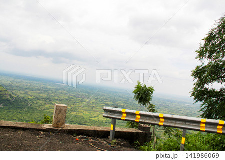 Green Valley Landscape with Hills and Farmland View Green Valley Landscape with Hills and Farmland View 141986069