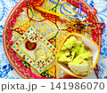 Raksha Bandhan thali with rakhi, rice, kumkum and sweets on a de 141986070