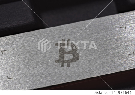 Close-up of Bitcoin Symbol Etched on Brushed Metal Surface Close-up of Bitcoin Symbol Etched on Brushed Metal Surface 141986644