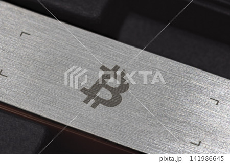 Close-up of Brushed Metal Surface with Bitcoin Symbol Close-up of Brushed Metal Surface with Bitcoin Symbol 141986645