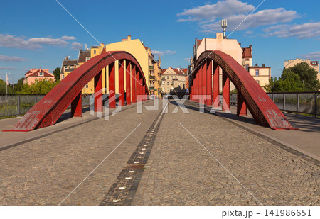 Red Steel Arch Bridge in Poznan, Poland on a Sunny Day Red Steel Arch Bridge in Poznan, Poland on a Sunny Day 141986651