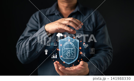 Man hands holding shield padlock hologram with cloud and network icons. Cybersecurity concept for data protection, privacy safety, digital defense, and secure internet technology system. Man hands holding shield padlock hologram with cloud and network icons. Cybersecurity concept for data protection, privacy safety, digital defense, and secure internet technology system. 141988330
