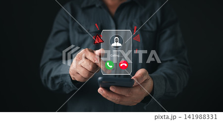 Man hand holding phone receiving unknown scam call with hacker hologram. Cyber security concept showing incoming fraud alert, voice phishing danger, identity theft, and digital crime warning. Man hand holding phone receiving unknown scam call with hacker hologram. Cyber security concept showing incoming fraud alert, voice phishing danger, identity theft, and digital crime warning. 141988331
