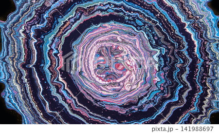 Concentric fluid paint rings in pink blue and purple resembling geode cross section 141988697