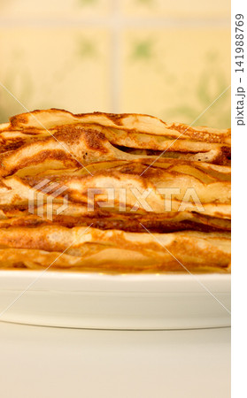 Pancakes lying on a plate. 141988769