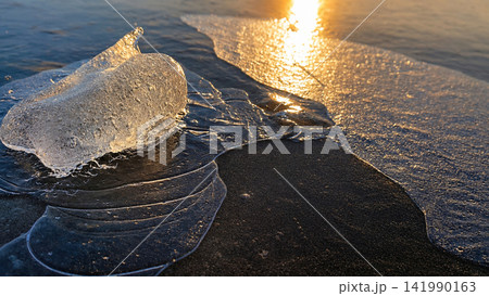 Glacial Ice on a Frozen River at Golden Sunset Glacial Ice on a Frozen River at Golden Sunset 141990163