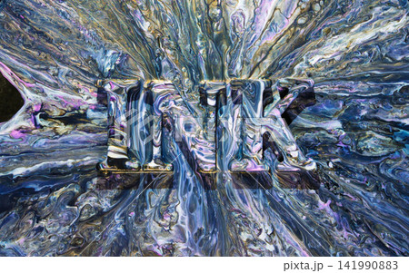 Marbled paint letters M T K emerging from swirling metallic blue and purple pour Marbled paint letters M T K emerging from swirling metallic blue and purple pour 141990883