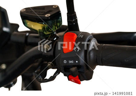 Close up of motorcycle handlebar with red engine kill switch and control panel on white background. 141991081