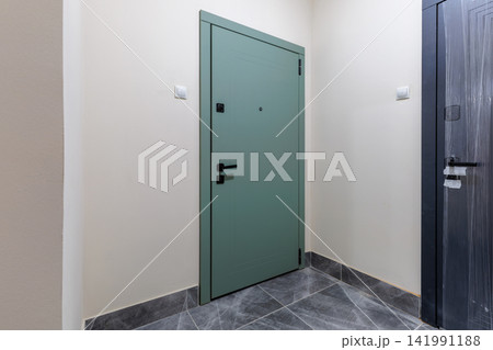 Apartment Entryway Interior with Green Entrance Door and Tiled Floor Apartment Entryway Interior with Green Entrance Door and Tiled Floor 141991188