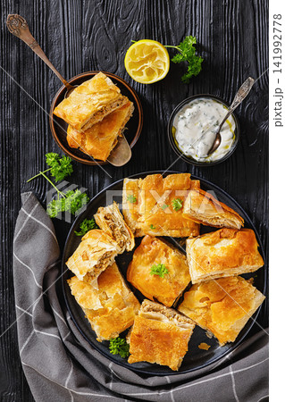 Crispy phyllo ground meat pie cut into squares Crispy phyllo ground meat pie cut into squares 141992778