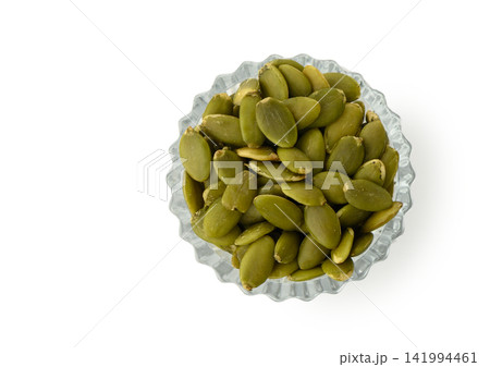 Overhead View of Faceted Glass Bowl with Shelled Green Pumpkin Seeds Overhead View of Faceted Glass Bowl with Shelled Green Pumpkin Seeds 141994461