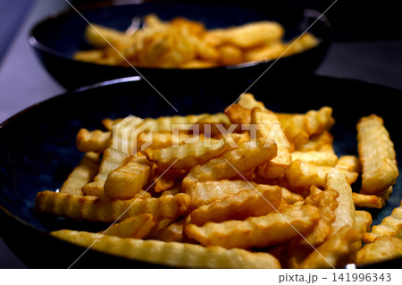 Golden Crispy French Fries in Blue Ceramic Plates - Perfect Shareable Snack Inspiration Golden Crispy French Fries in Blue Ceramic Plates - Perfect Shareable Snack Inspiration 141996343