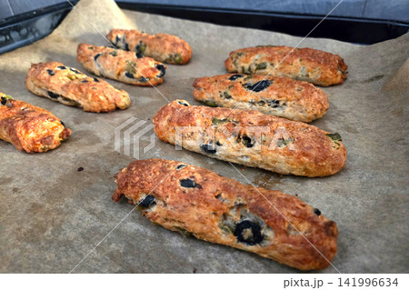Savory Homemade Olive and Herb Breadsticks on Baking Tray - Perfect for Appetizers and Snacks Savory Homemade Olive and Herb Breadsticks on Baking Tray - Perfect for Appetizers and Snacks 141996634