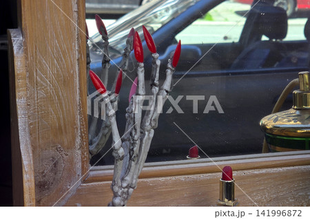Creative Window Display with Skeleton Hand and Red Lipstick for Unique Retail Design Creative Window Display with Skeleton Hand and Red Lipstick for Unique Retail Design 141996872