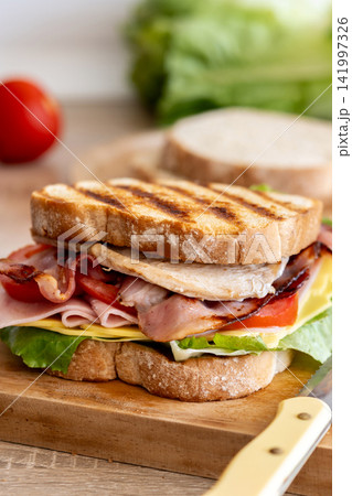 Grilled club sandwich with bacon and ham Grilled club sandwich with bacon and ham 141997326