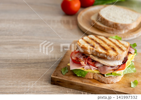 Grilled club sandwich with bacon and ham Grilled club sandwich with bacon and ham 141997332